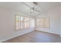 Dining room featuring vinyl plank flooring, modern lighting, and plantation shutters at 16609 S 41St St, Phoenix, AZ 85048