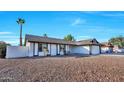 Single-story home boasting a xeriscaped front yard and a painted privacy wall at 1720 W Highland St, Chandler, AZ 85224