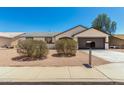 Charming single-story home featuring a two-car garage, neutral colors, and low-maintenance landscaping at 1727 W 12Th Ave, Apache Junction, AZ 85120
