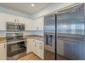 Well-equipped kitchen features stainless steel appliances, white cabinets, and neutral countertops at 1886 E Don Carlos Ave # 136, Tempe, AZ 85281