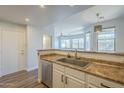 Kitchen features stainless steel dishwasher and sink, white cabinets and a neutral countertop at 1886 E Don Carlos Ave # 136, Tempe, AZ 85281