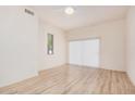 Bright bedroom features wood-look floors, a ceiling fan, and sliding patio doors at 205 N 74Th St # 110, Mesa, AZ 85207
