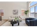 Well-lit living room featuring neutral colors, two couches, and large windows for natural light at 2421 S 65Th Dr, Phoenix, AZ 85043