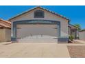 Spacious two-car garage with a clean, well-maintained door and exterior at 3014 W Zachary Dr, Phoenix, AZ 85027