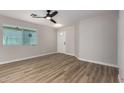 Bright living room featuring sleek hardwood floors, a modern ceiling fan, and ample natural light at 3014 W Zachary Dr, Phoenix, AZ 85027