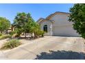An attractive single-story home with a well maintained driveway and desert landscaping at 3553 W Dancer Ln, San Tan Valley, AZ 85144