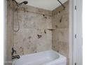 Close-up of shower/tub combo with unique patterned tile and chrome showerhead at 3619 E Monterosa St # 202, Phoenix, AZ 85018