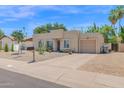 Attractive home featuring a well-maintained desert landscape and a convenient attached two-car garage at 3919 E Larkspur Dr, Phoenix, AZ 85032