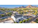 An aerial view showcases a white home with a well-maintained backyard, pergola, and a pool at 4131 E Roma Ave, Phoenix, AZ 85018