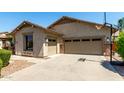 An attached two-car garage with a basketball hoop and low maintenance landscaping at 418 W Balsam Dr, Chandler, AZ 85248