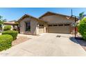 An attached two-car garage with a basketball hoop and low maintenance landscaping at 418 W Balsam Dr, Chandler, AZ 85248