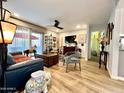 Spacious living area with wood floors, ceiling fan, sliding glass doors and stylish decor at 4554 E Paradise Village N Pkwy # 133, Phoenix, AZ 85032
