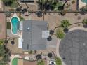 Expansive backyard featuring a sparkling pool, mature trees, and serene landscaping at 4812 W Butler Dr, Chandler, AZ 85226