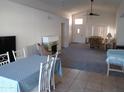 Bright living room with vaulted ceilings, fireplace, and views of dining room and entryway at 5323 W North Ln, Glendale, AZ 85302