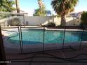 Inviting private pool with a safety fence, set in a well-maintained backyard oasis at 5323 W North Ln, Glendale, AZ 85302