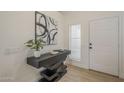 Modern entryway with floating console table, decorative art, and bright natural light at 6029 E Palm St, Mesa, AZ 85215