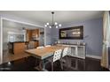 Inviting dining room with view to the kitchen, modern lighting and neutral paint at 7543 E Portland St, Scottsdale, AZ 85257