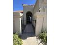 Charming entryway with iron gate, stucco pillars, and arched entrance, creating a welcoming feel at 7725 W Mcrae W Way, Glendale, AZ 85308
