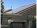 Home exterior featuring solar panels on the roof, offering energy efficiency and modern appeal at 7725 W Mcrae W Way, Glendale, AZ 85308