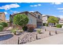 Lovely front yard with desert landscaping, decorative rocks, small flowering bushes, and a paved walkway at 1124 E Jahns Dr, Casa Grande, AZ 85122