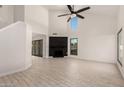 Bright living room boasting vaulted ceilings, wood-look tile flooring, and a black shiplap fireplace at 1621 N Chippewa Dr, Chandler, AZ 85224