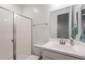 Clean, bright bathroom with white vanity, framed mirror, and walk-in shower with glass door at 1744 W Hopi Dr, Coolidge, AZ 85128