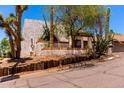 Desert landscaped home with a stucco wall exterior and a brown tile roof at 1831 N 77Th St, Scottsdale, AZ 85257