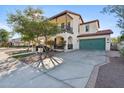 Beautiful home showcasing a balcony, two-car garage, and lovely landscaping at 20518 W White Rock Rd, Buckeye, AZ 85396