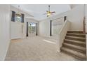 Bright living room showcasing soaring ceilings, carpet floors, and a staircase to upper floor at 2511 W Blue Sky Dr, Phoenix, AZ 85085
