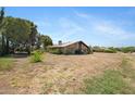 Expansive property displaying a charming brick house amid desert landscaping, blending comfort and natural beauty at 2921 N 103Rd Ave, Avondale, AZ 85392