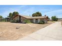 Beautiful brick home showcasing a unique design, surrounded by natural landscaping, epitomizing tranquil desert living at 2921 N 103Rd Ave, Avondale, AZ 85392