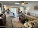 Open-concept living room and kitchen with wood floors, neutral tones, stainless steel appliances, and a large area rug at 3615 E Hearn Rd, Phoenix, AZ 85032