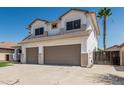 Two-story home features a two-car garage, green lawn, desert landscaping, and a palm tree at 3851 E San Pedro Ave, Gilbert, AZ 85234