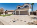 Two-story home features a two-car garage, green lawn, desert landscaping, and a palm tree at 3851 E San Pedro Ave, Gilbert, AZ 85234