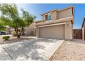 Beige two-story home with concrete driveway and desert landscaping surrounding the property at 3910 W Goldmine Mountain Dr, San Tan Valley, AZ 85144
