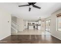 Spacious open-concept living room with tile flooring, staircase, and view of the kitchen at 3910 W Goldmine Mountain Dr, San Tan Valley, AZ 85144