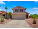 Inviting two-story home displaying an attached garage, low maintenance yard, and tasteful desert landscaping at 4043 E Mountain Vista Dr, Phoenix, AZ 85048