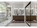 Elegant bathroom showcasing double vanities, a glass-enclosed shower, and a large mirrored closet at 5330 W Folley W St, Chandler, AZ 85226