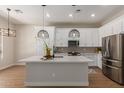 Modern kitchen featuring stainless steel appliances, white cabinets, and a large center island at 5330 W Folley W St, Chandler, AZ 85226