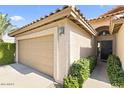 Close up on attached two-car garage and front door at 5450 E Paradise Ln, Scottsdale, AZ 85254