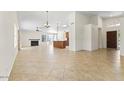 Open-concept living room with tile flooring, high ceilings, and fireplace at 5450 E Paradise Ln, Scottsdale, AZ 85254