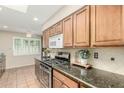Cozy kitchen features wood cabinets, stainless steel oven range, and a sunny window at 6025 N 10Th Pl, Phoenix, AZ 85014