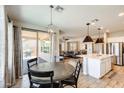 Cozy dining area with a modern chandelier, adjacent to the kitchen and living area at 699 S 197Th Dr, Buckeye, AZ 85326