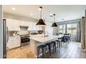 Modern kitchen boasts stainless steel appliances, a large island with seating, and stylish pendant lighting at 699 S 197Th Dr, Buckeye, AZ 85326