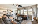 Bright living room featuring tile floors, a ceiling fan, and access to the backyard and kitchen at 699 S 197Th Dr, Buckeye, AZ 85326
