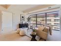 Inviting living room with modern decor, large window, and comfortable seating area at 7151 E Rancho Vista Dr # 6002, Scottsdale, AZ 85251
