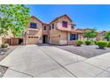 Two-story home boasting great curb appeal with a large concrete driveway and lush landscaping in front at 742 E Kingbird Dr, Gilbert, AZ 85297