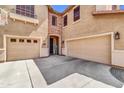Attached two-car garage and front door with stone archway on a well-maintained home at 742 E Kingbird Dr, Gilbert, AZ 85297