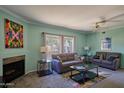 Inviting living room with fireplace, comfortable sofas, neutral paint, and bright natural light at 750 E Northern Ave # 2088, Phoenix, AZ 85020