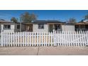View of this single Gathering house with a white picket fence and green front door at 826 S Drew St, Mesa, AZ 85210